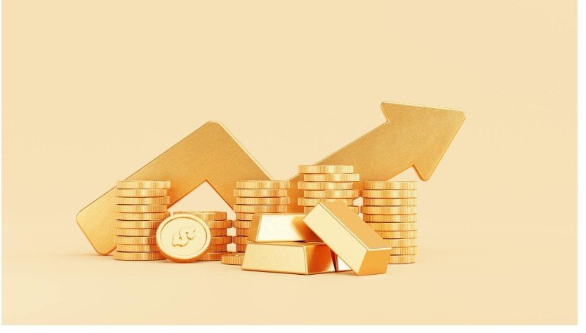 Gold bars and coins with rising investment arrow